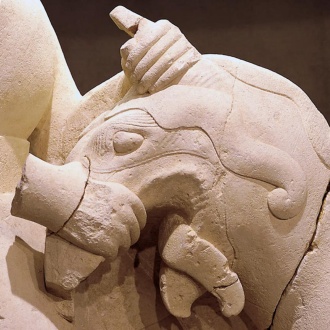 Detail of the sculpture griphomaquia depicting a man fighting a griffin. 5th century