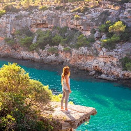 Tourist contemplating Cala Pi in Mallorca, Balearic Islands