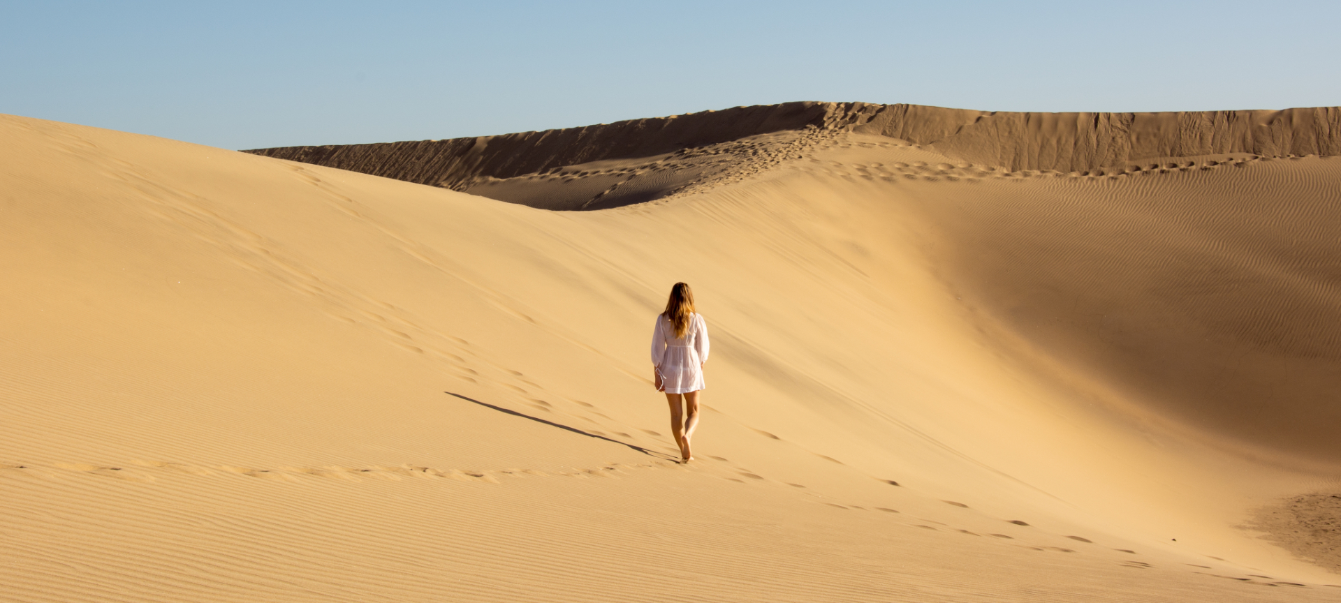 Un turista nella Riserva Naturale Speciale delle Dune di Maspalomas a Gran Canaria, Isole Canarie Un turista nella Riserva Naturale Speciale delle Dune di Maspalomas a Gran Canaria, Isole Canarie