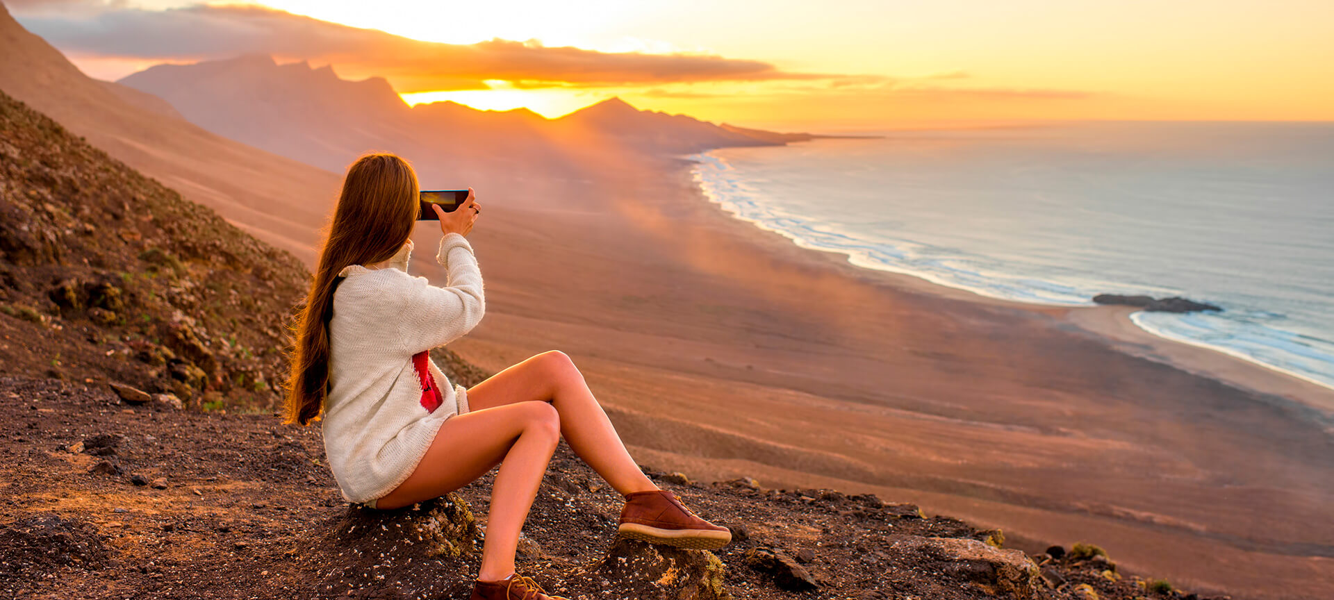 Girl taking photos on Cofete beach, Fuerteventura Girl taking photos on Cofete beach, Fuerteventura
