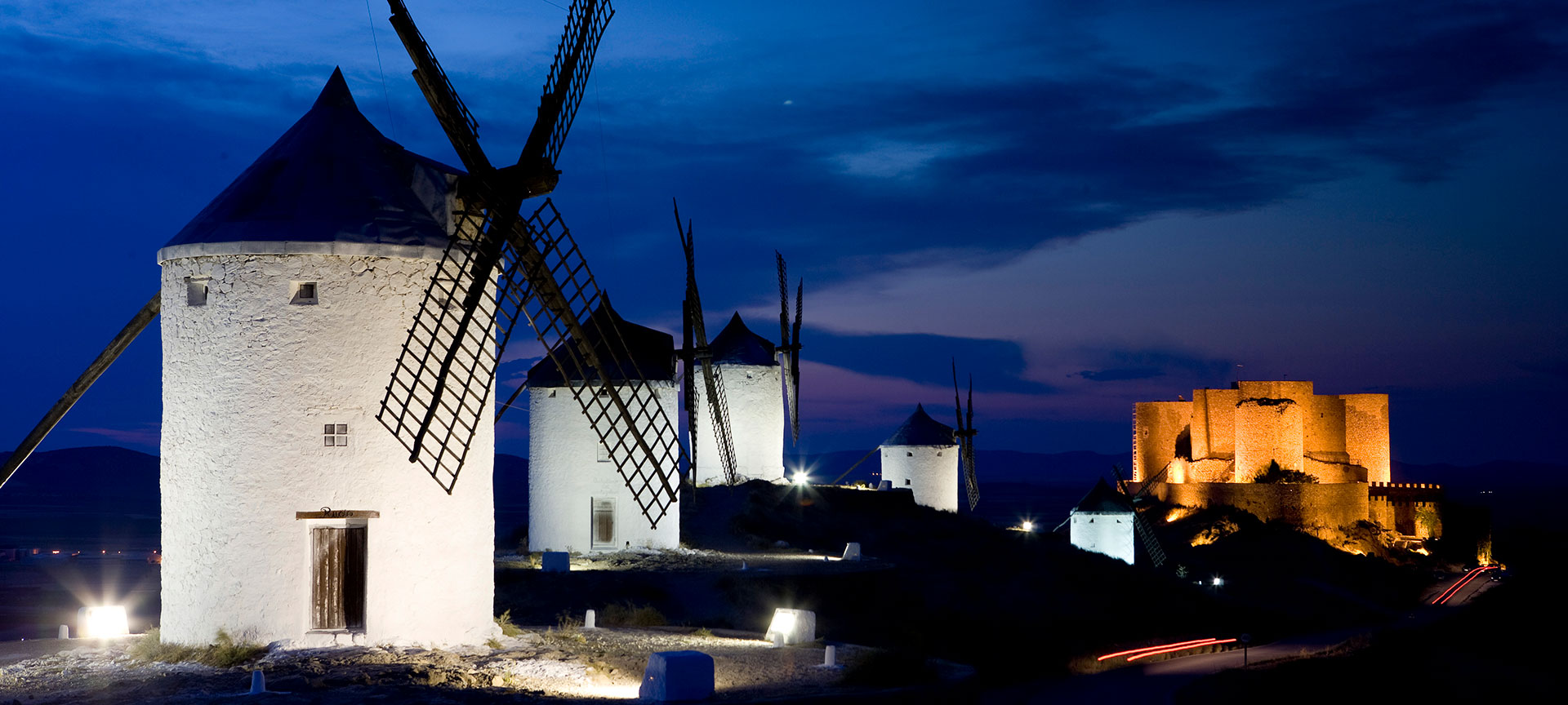 View of the windmills at night, with Consuegra Castle in the background. Toledo View of the windmills at night, with Consuegra Castle in the background. Toledo