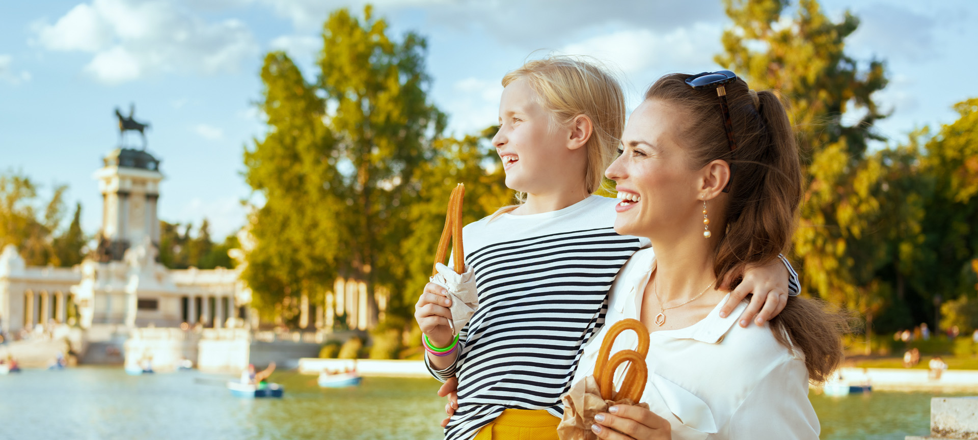Madre e hija degustando churros en el Parque del Retiro de Madrid, Comunidad de Madrid Madre e hija degustando churros en el Parque del Retiro de Madrid, Comunidad de Madrid