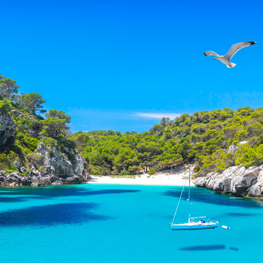 The turquoise waters of Cala Macarella in Menorca The turquoise waters of Cala Macarella in Menorca