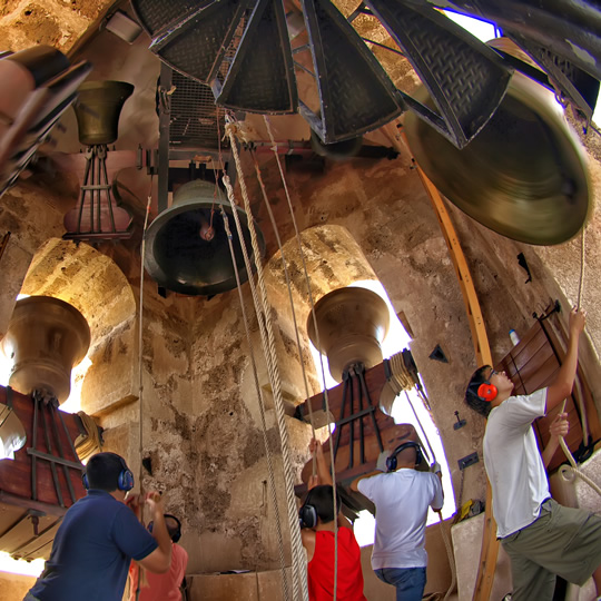 Bell ringers ringing the bells inside the bell tower, Albaida Bell ringers ringing the bells inside the bell tower, Albaida