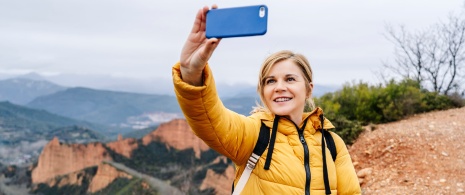 Pilgrim taking a photo on the Roman road in Las Médulas, Castile and León