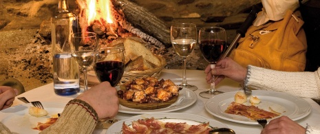 Couple enjoying wine and various tapas